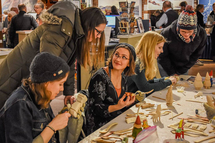 Students in Luther College Scandinavian Studies class demonstrate woodcarving at Vesterheim Museum