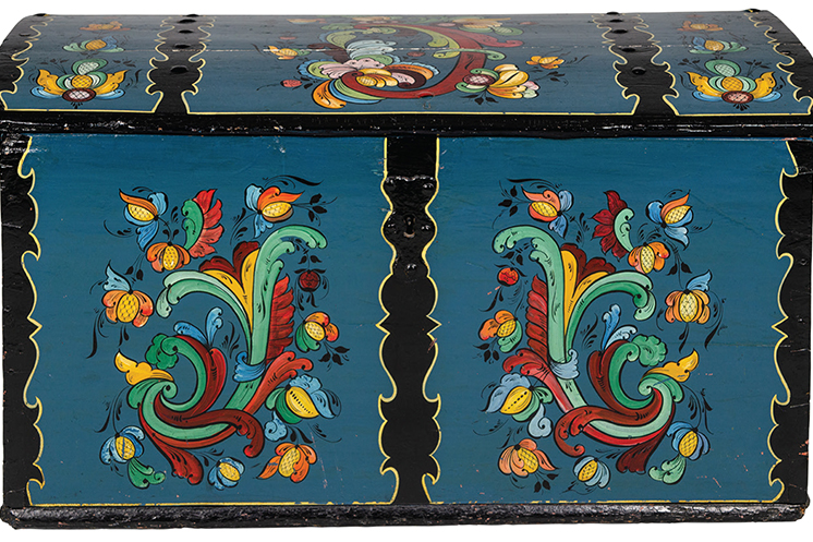 Wooden trunk painted by Per Lysne and carried from Norway to American by Herborg Tvedt. From Vesterheim collection.