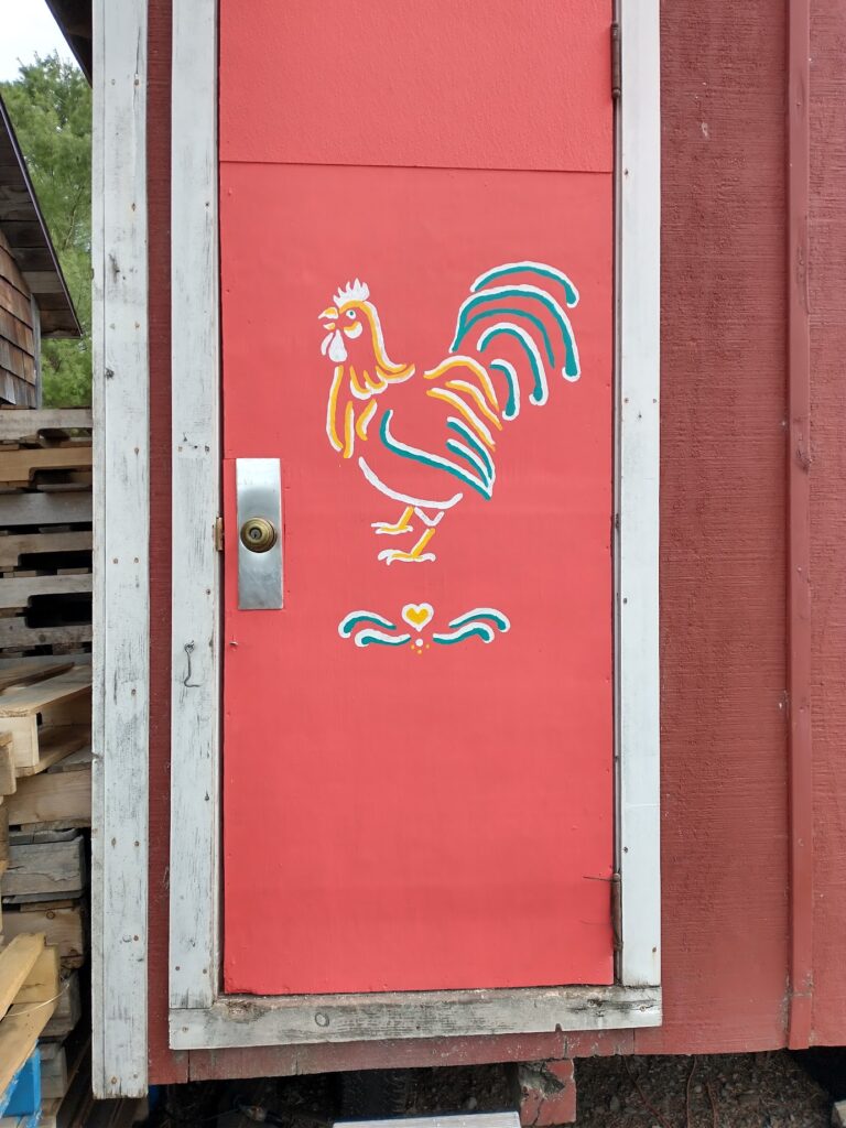 Chicken coop door painted with rooster by Laura Berlage